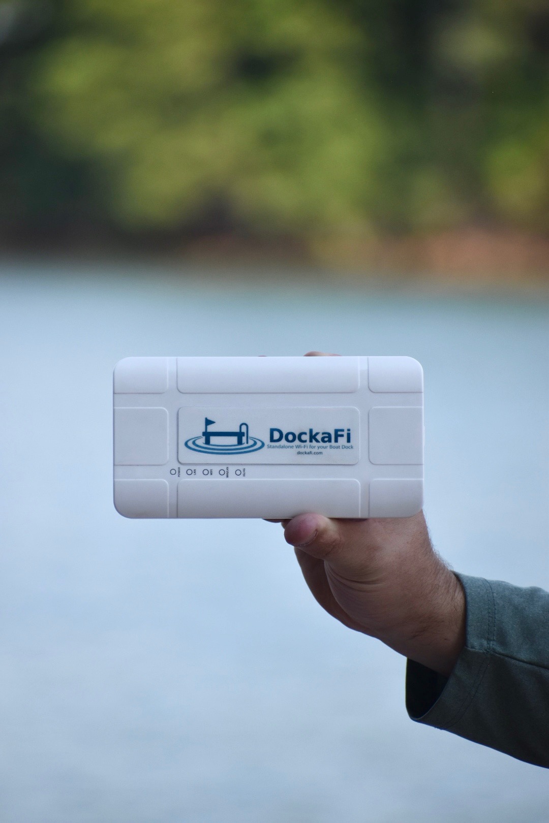 DockaFi device held by hand in front of the water